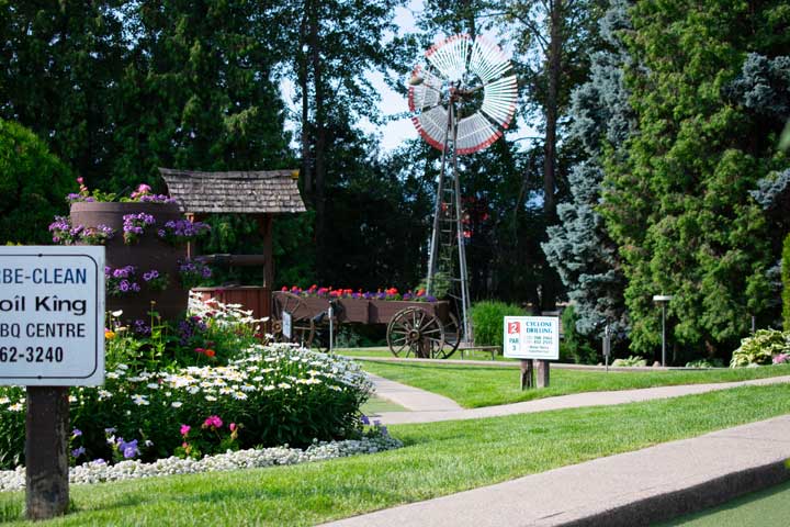 Windmill, flower beds and putting greens at Scandia Golf & Games in Kelowna.